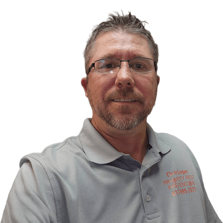 A man wearing a grey shirt and glasses, looking directly at the camera with a neutral expression.